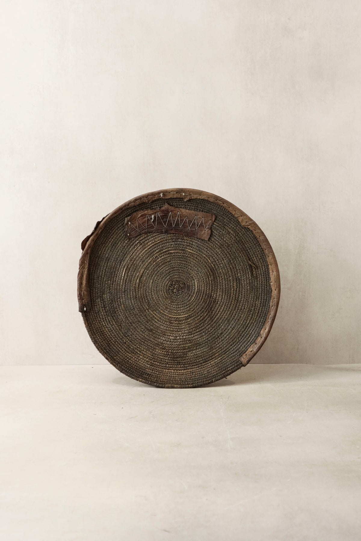 Handwoven wall basket from Chad by Botanical Boys, featuring natural fibers and intricate craftsmanship for wall decor.