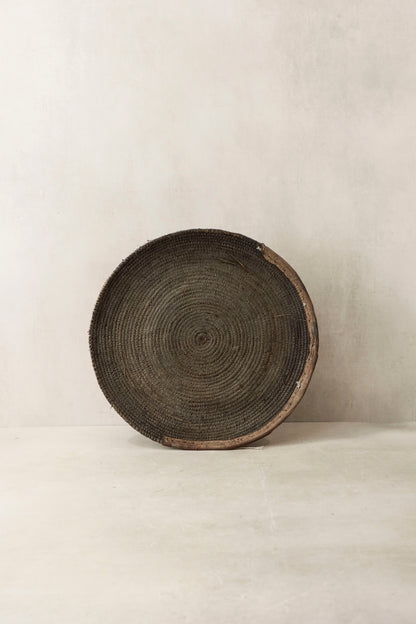 Handwoven wall basket from Chad by Botanical Boys, showcasing intricate craftsmanship and natural fibers in a decorative wall piece.