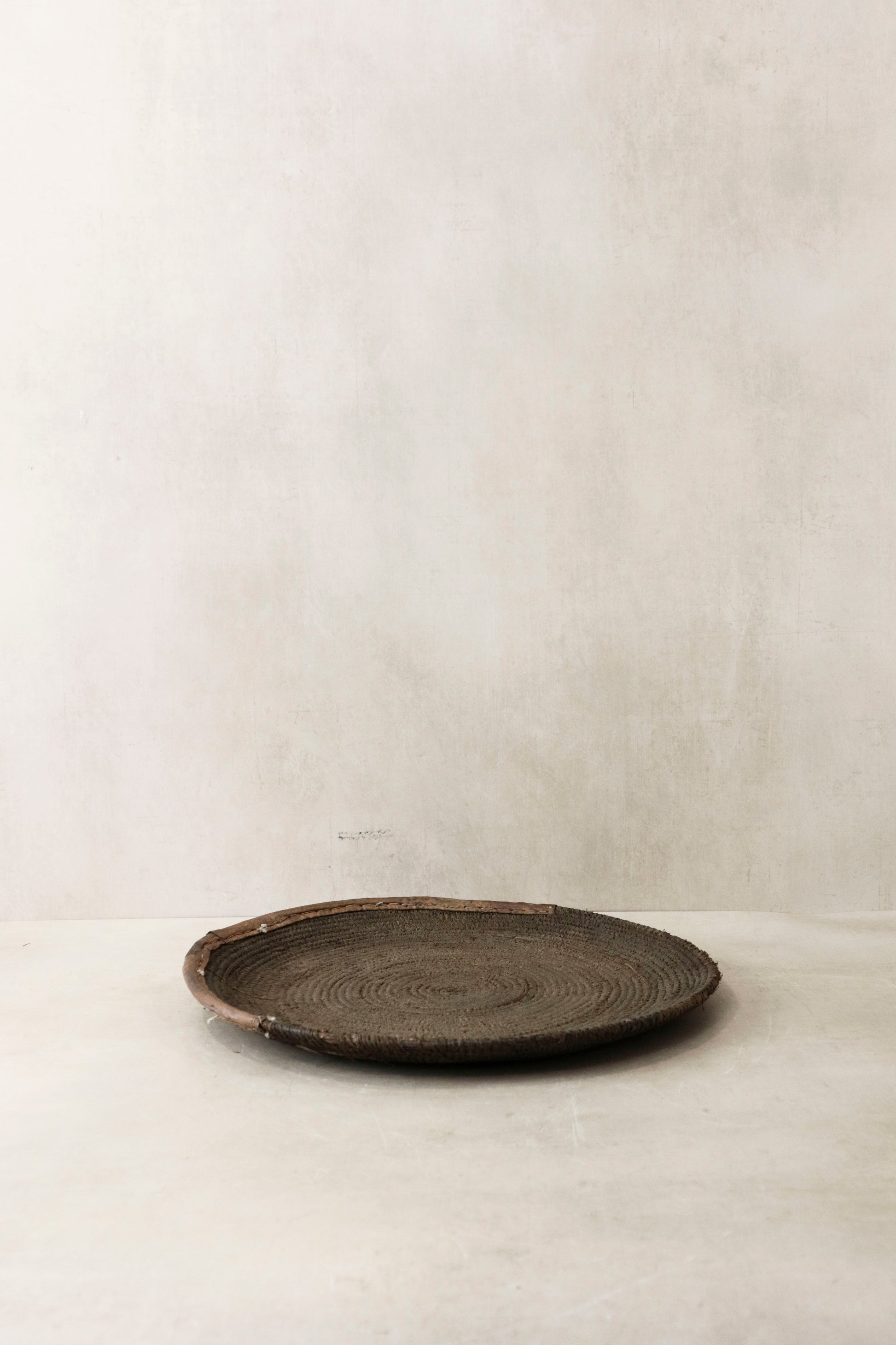 Handwoven wall basket from Chad by Botanical Boys, showcasing intricate natural fibers and rustic wall decor design.