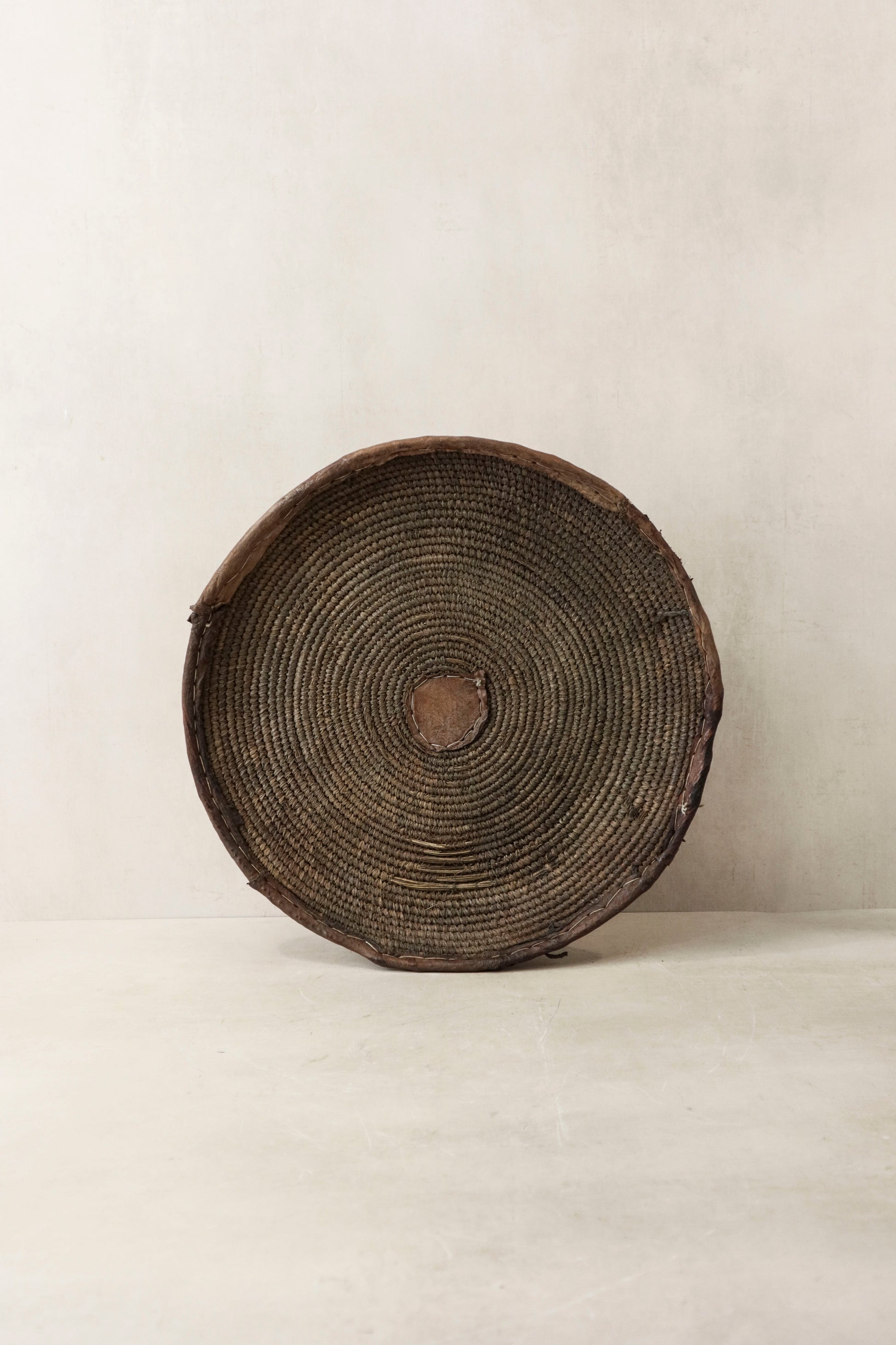 Handwoven wall basket from Chad by Botanical Boys, showcasing intricate natural fibers and artisanal craftsmanship.