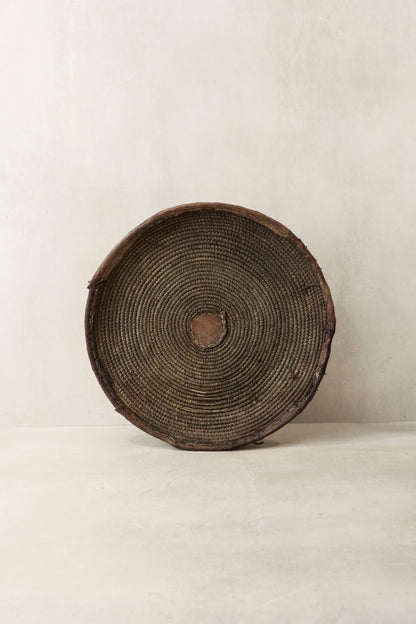 Handwoven wall basket from Chad by Botanical Boys, showcasing intricate natural fibers and artisanal craftsmanship.