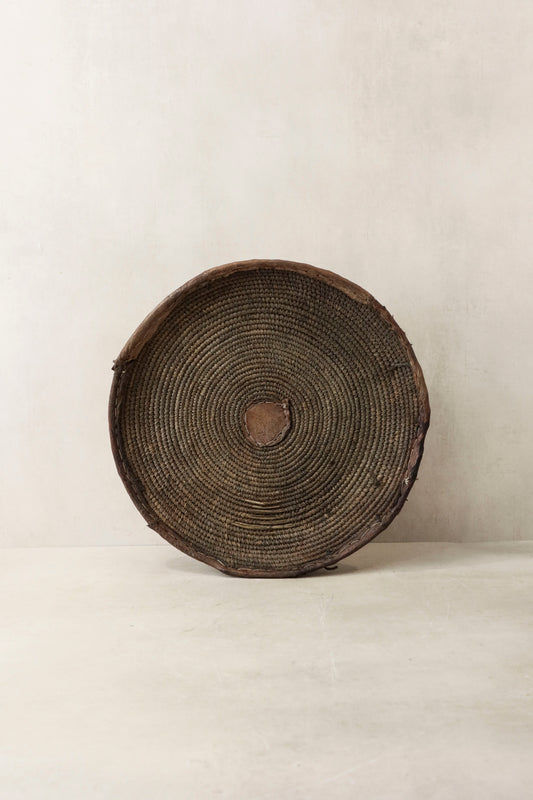 Handwoven wall basket from Chad by Botanical Boys, showcasing intricate natural fibers and artisanal craftsmanship.