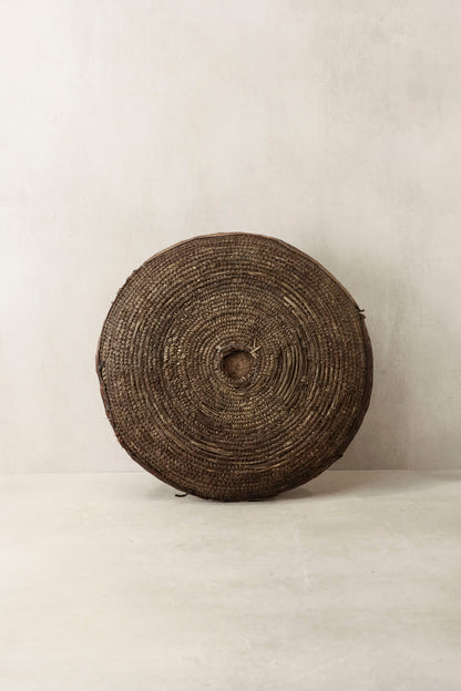 Handwoven wall basket from Chad by Botanical Boys, featuring natural fibers and intricate craftsmanship, designed for wall decor.