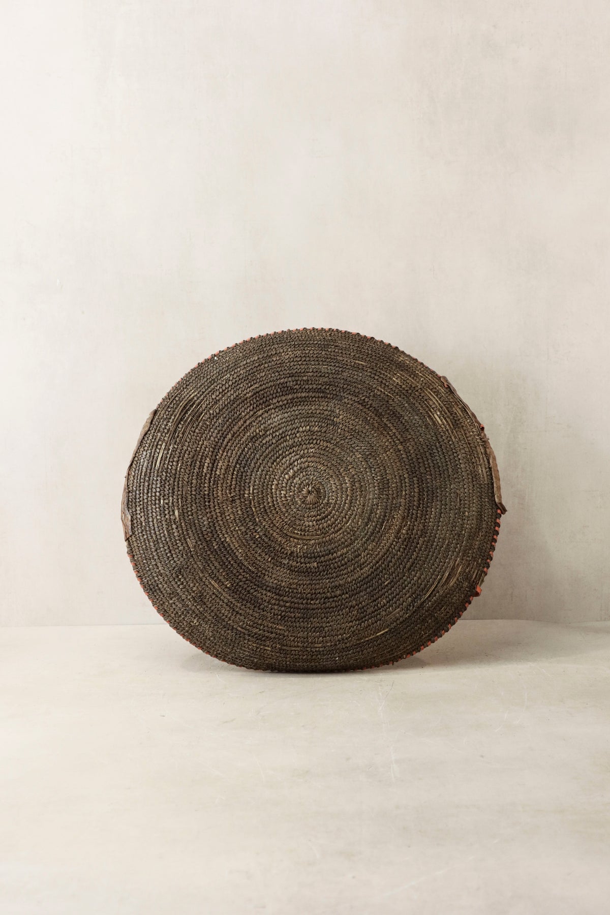 Handwoven wall basket by Botanical Boys, Chad style, featuring natural fibers and intricate weaving, perfect for decorative wall display.