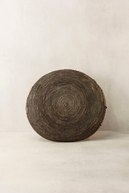 Handwoven wall basket by Botanical Boys, Chad style, featuring natural fibers and intricate weaving, perfect for decorative wall display.