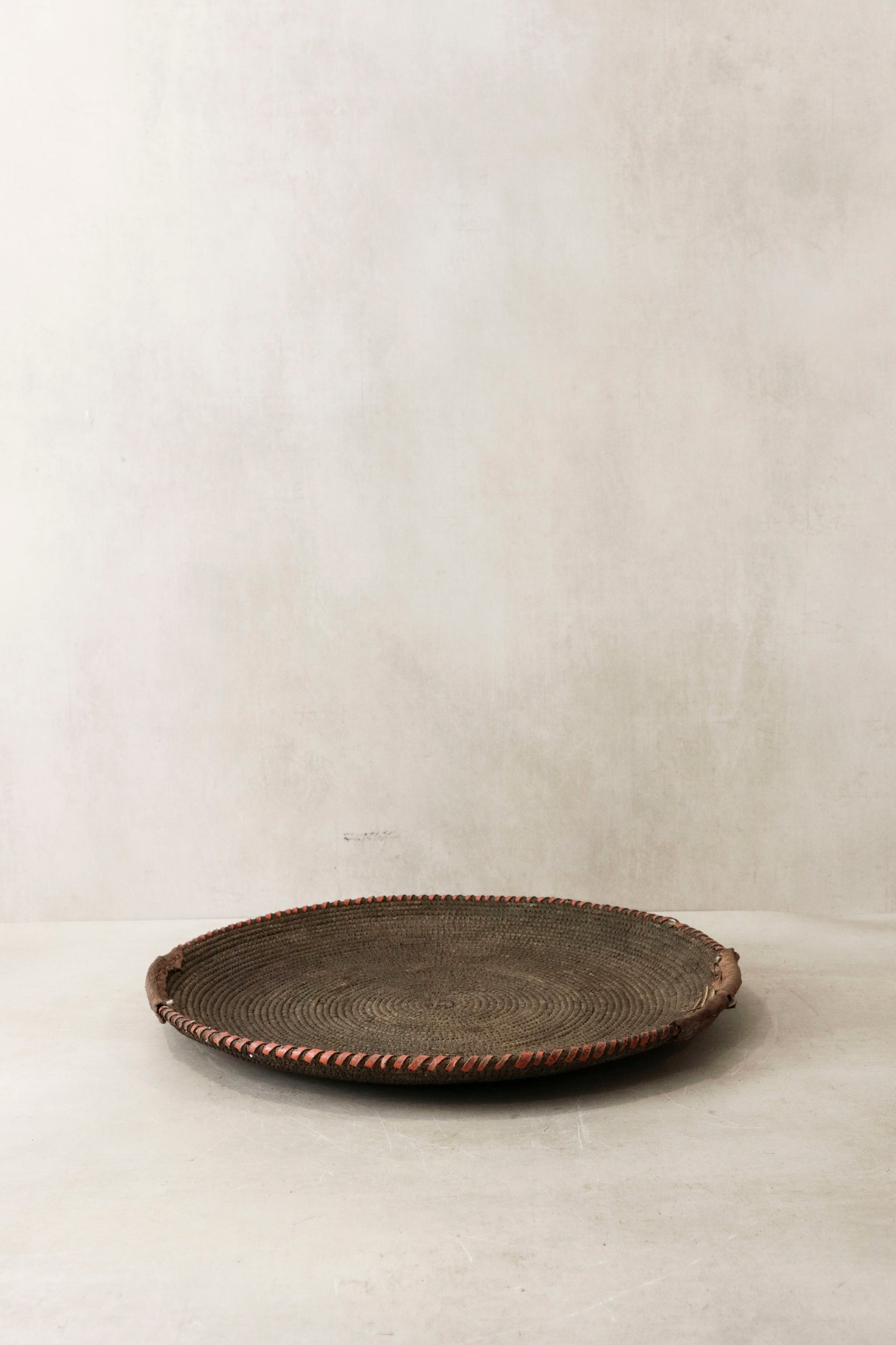 Handwoven wall basket from Chad by Botanical Boys, featuring natural fibers and intricate craftsmanship for wall decor.