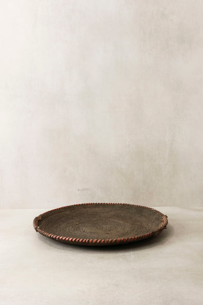 Handwoven wall basket from Chad by Botanical Boys, featuring natural fibers and intricate craftsmanship for wall decor.