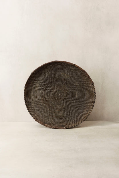 Handwoven wall basket from Chad by Botanical Boys, featuring natural fibers and intricate weaving, ideal for wall decor.