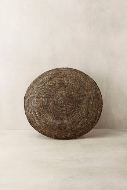 Handwoven Chad wall basket by Botanical Boys, featuring intricate natural fibers and a circular shape for rustic decor.