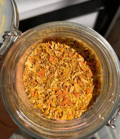 Bottle of Porter Hill Tea Company's Glow fruit and herbal tea, showcasing fresh ingredients and vibrant packaging.
