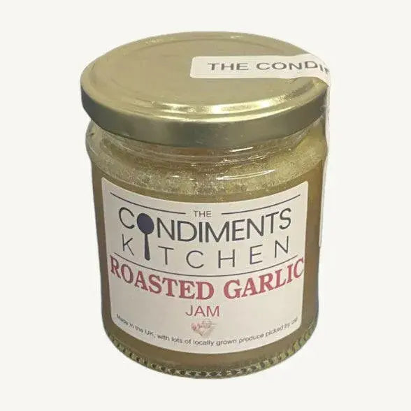 Jar of The Condiments Kitchen Roasted Garlic Jam chutney, showing the label and jar with garlic and relish inside.