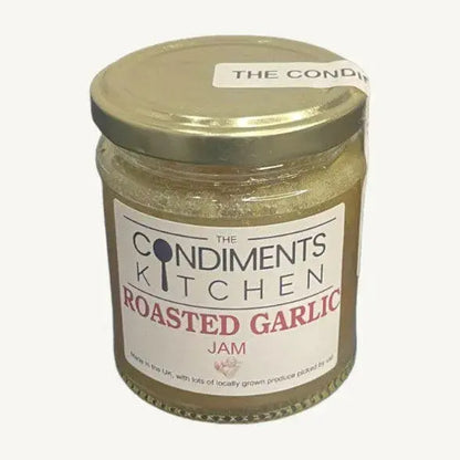 Jar of The Condiments Kitchen Roasted Garlic Jam chutney, showing the label and jar with garlic and relish inside.
