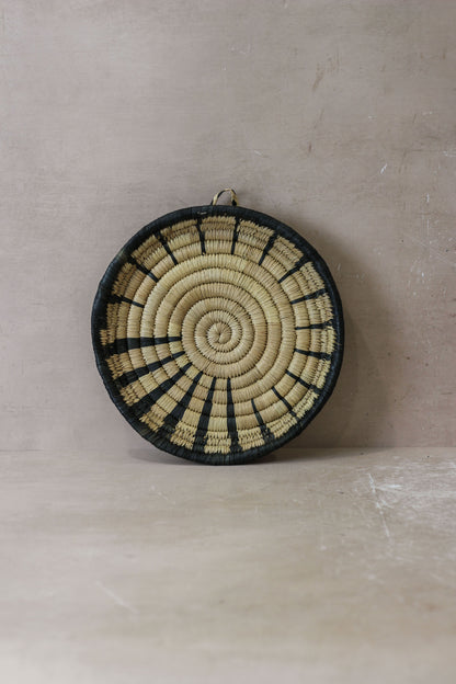Small Malawi Wall Basket No 2 by Botanical Boys, woven natural basket for wall decor, showcasing its textured design and compact size.