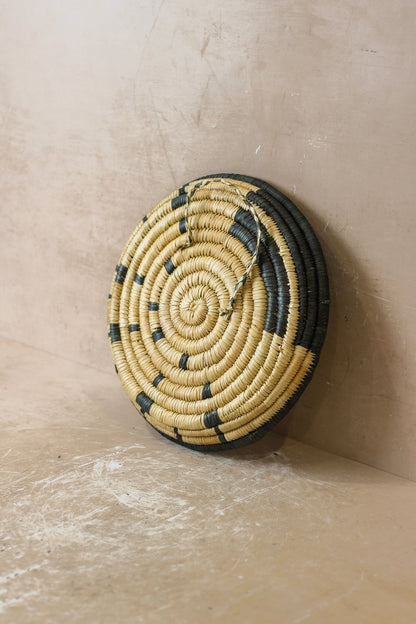 Small Malawi Wall Basket No 5 by Botanical Boys, decorative woven wall art with intricate patterns and natural fibers.