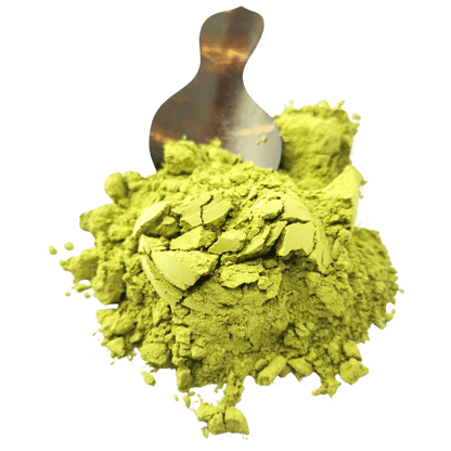 Porter Hill Tea Company Izu Matcha green tea powder in a green container with a scoop and tea leaves on a wooden surface.