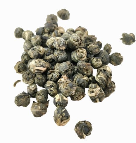 Porter Hill Tea Company Jasmine Dragon Pearls green tea with crafted white pearls and fresh jasmine blossoms in a close-up image.