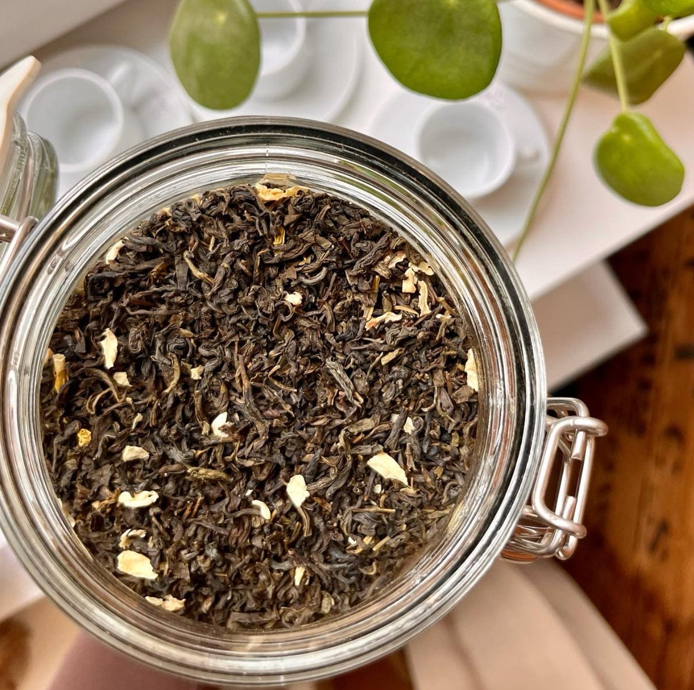 Fresh jasmine green tea leaves from Porter Hill Tea Company, showcasing bright green tea leaves and jasmine blossoms.