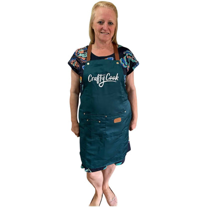 Teal Crafty Cook apron with multiple pockets, designed for cooking and baking, featuring a comfortable fit and durable fabric.