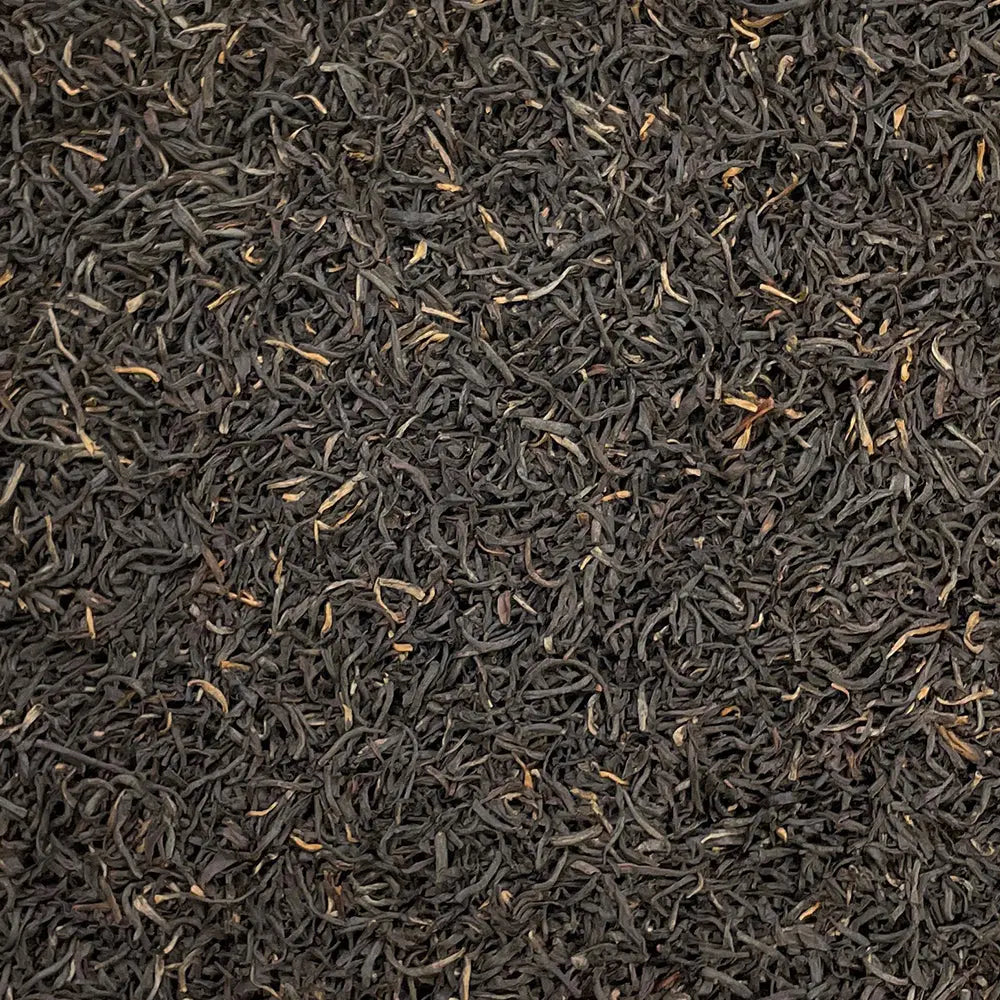 Loose leaf Kenya Kosabei Estate TGFOP tea by High Teas, showing dark, rolled tea leaves in a close-up view.