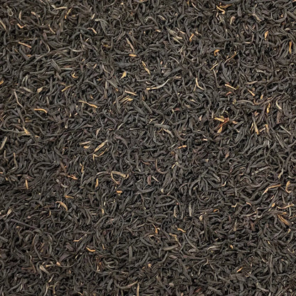 Loose leaf Kenya Kosabei Estate TGFOP tea by High Teas, showing dark, rolled tea leaves in a close-up view.