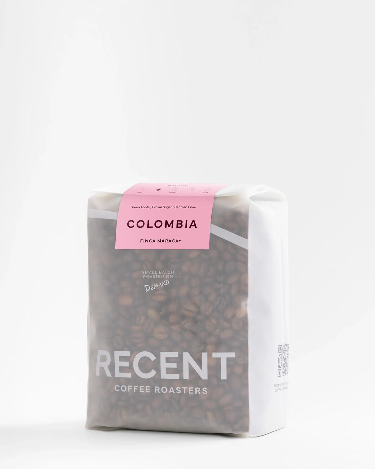 Recent Beans Colombia Finca Maracay medium roast coffee bag, 500g, featuring vibrant pink design and fresh coffee beans.