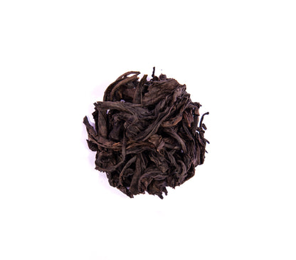 Limited edition Zhou Family handmade Wuyi Da Hong Pao tea leaves from PekoeTea Edinburgh, showcasing dark, roasted tea leaves.