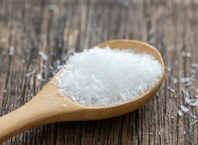 Fine MSG Monosodium Glutamate by Whole Food Earth in a clear container, showing white crystalline granules.