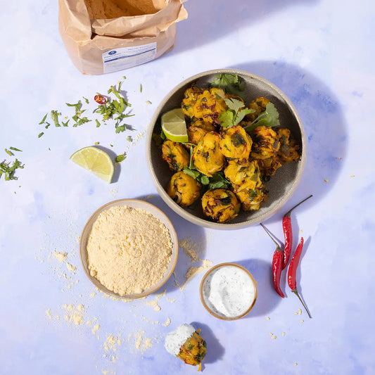 Bag of ArtisanBox maize flour from Serious Grains, showing a rustic kitchen setting with maize flour in a jar and surrounding ingredients.