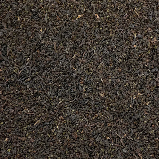 Loose leaf Manhattan Breakfast Tea by High Teas in a glass jar with tea leaves visible.