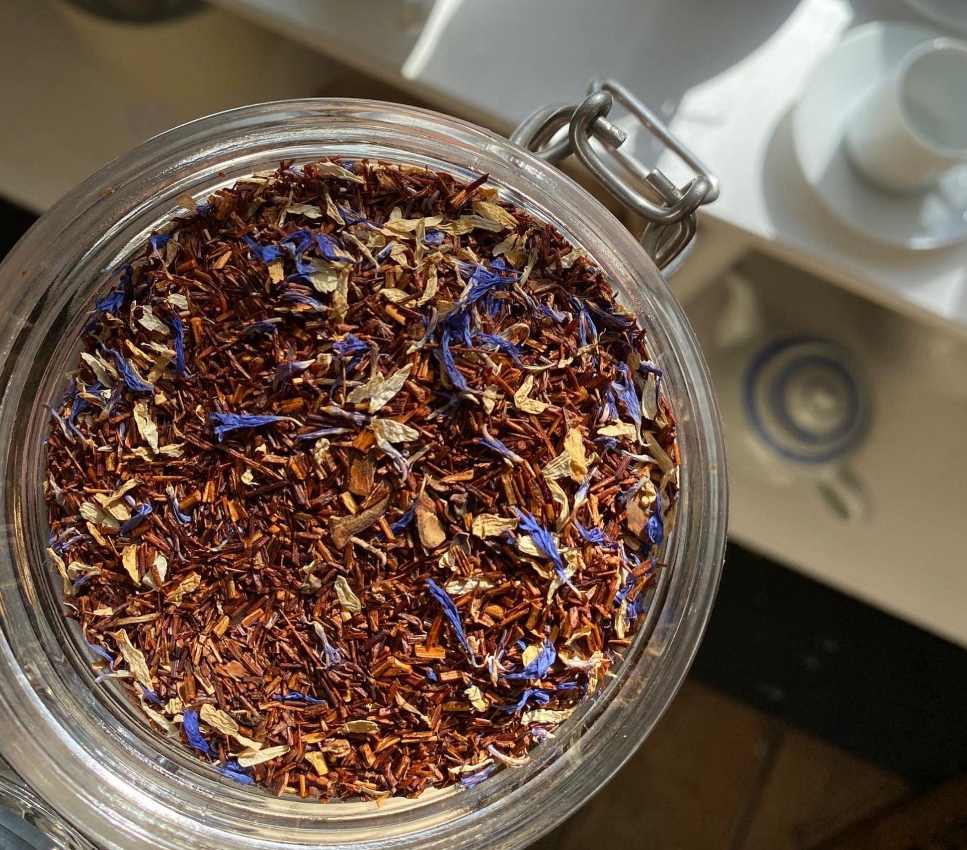 Organic Marzipan Rooibos tea from Porter Hill Tea Company in a tea bag, with dried rooibos and marzipan flavoring.