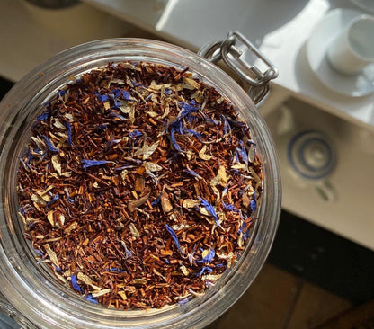 Organic Marzipan Rooibos tea from Porter Hill Tea Company in a tea bag, with dried rooibos and marzipan flavoring.