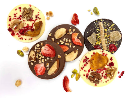 Group of handmade giant Mendiants with white chocolate, featuring assorted fruits and nuts, by Gorvett & Stone.