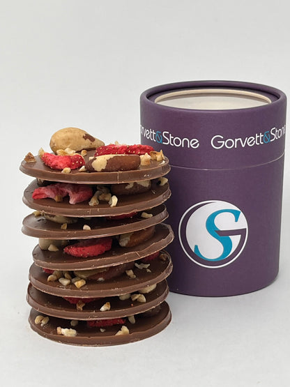 Stack of handmade milk chocolate mendiants with assorted dried fruits and nuts from Gorvett & Stone.