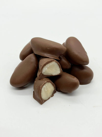 Milk chocolate-covered Brazil nuts from Gorvett & Stone, showcasing shiny, smooth chocolate coating on whole nuts.