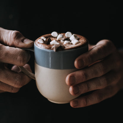 Harry's Hot Chocolate mug filled with creamy hot chocolate topped with whipped cream, showcasing a rich, comforting beverage.