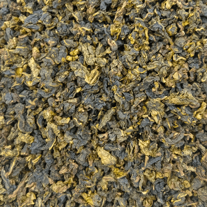 Loose leaf Milk Oolong tea from Porter Hill Tea Company, showcasing creamy, rolled tea leaves with a golden hue.