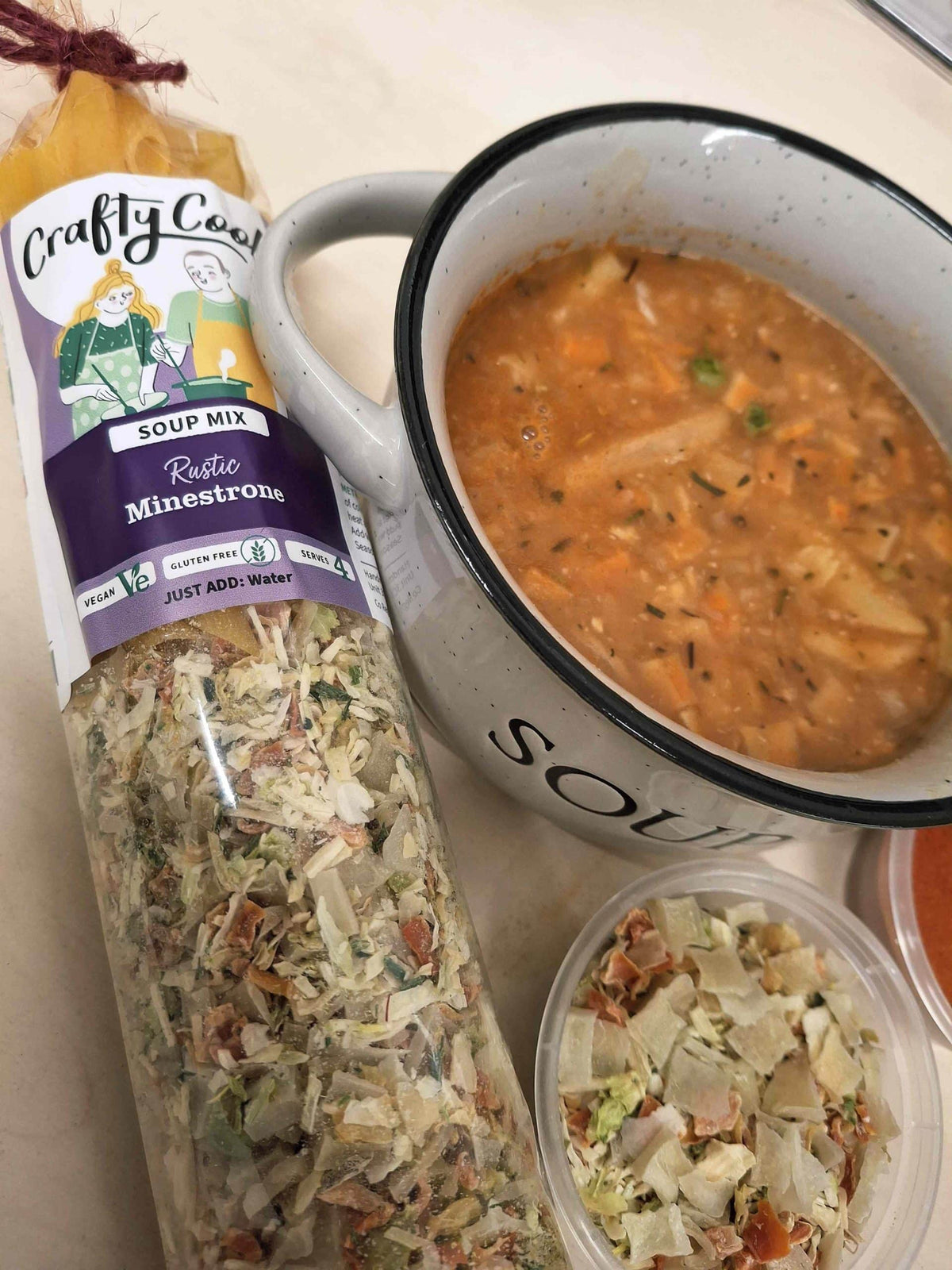 Crafty Cook Easy Meals Family Plan minestrone soup in a bowl with fresh vegetables and herbs, ready to serve.