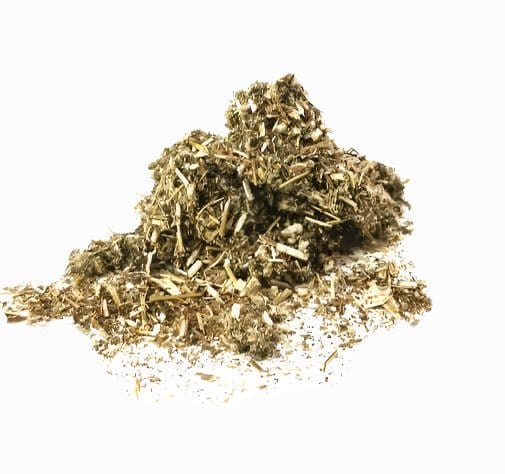 Porter Hill Tea Company Mugwort Tea, herbal fruit infusion in a glass teacup with fresh herbs and tea leaves.