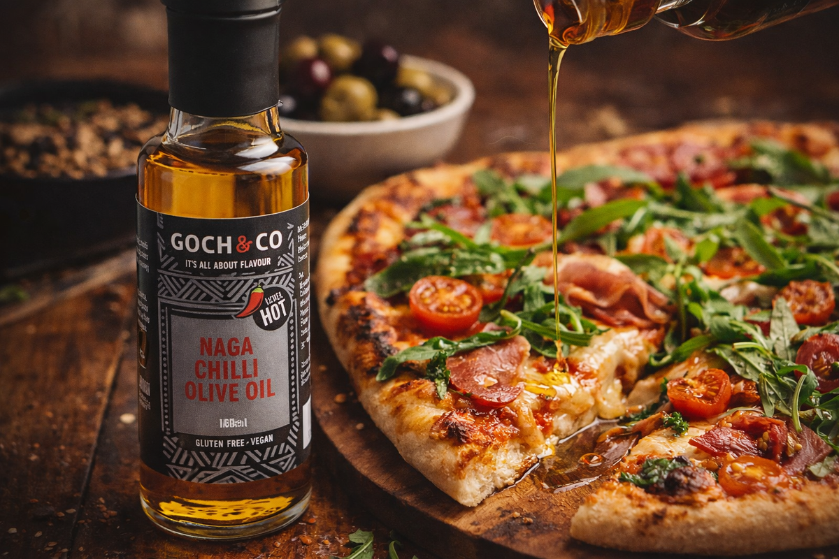 Goch & Co Naga Chilli Olive Oil bottle with red chili peppers and olive oil in a clear glass container.