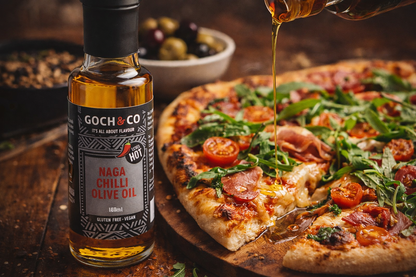 Goch & Co Naga Chilli Olive Oil bottle with red chili peppers and olive oil in a clear glass container.