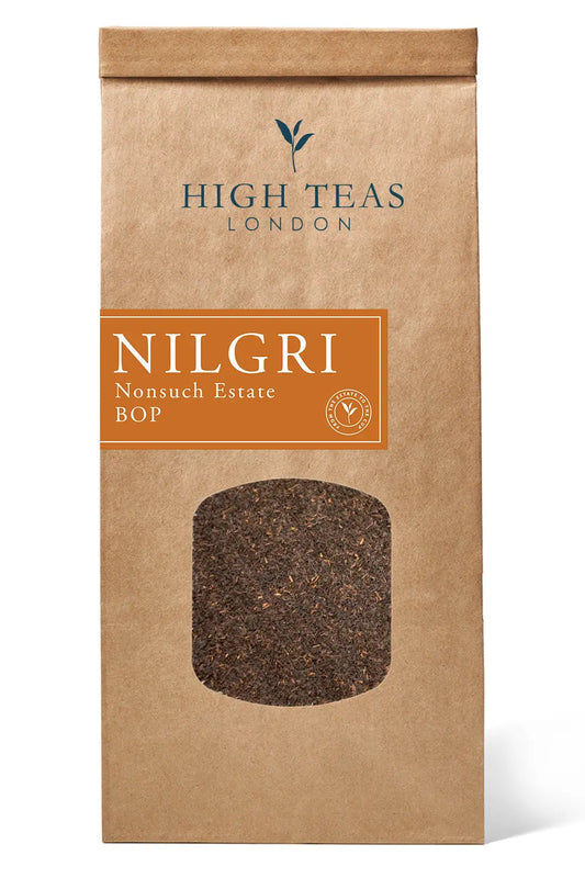 Loose leaf Honest Everyday Nilgiri BOP tea from High Teas, showcasing dark, twisted tea leaves in a clear glass jar.