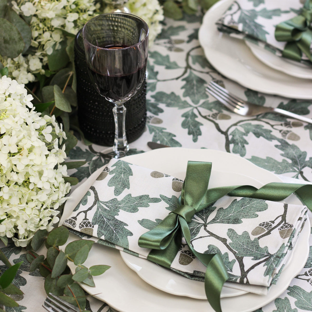 English Oak Tablecloth by Avalon Home UK draped over a wooden dining table, showcasing its natural oak pattern and elegant design.