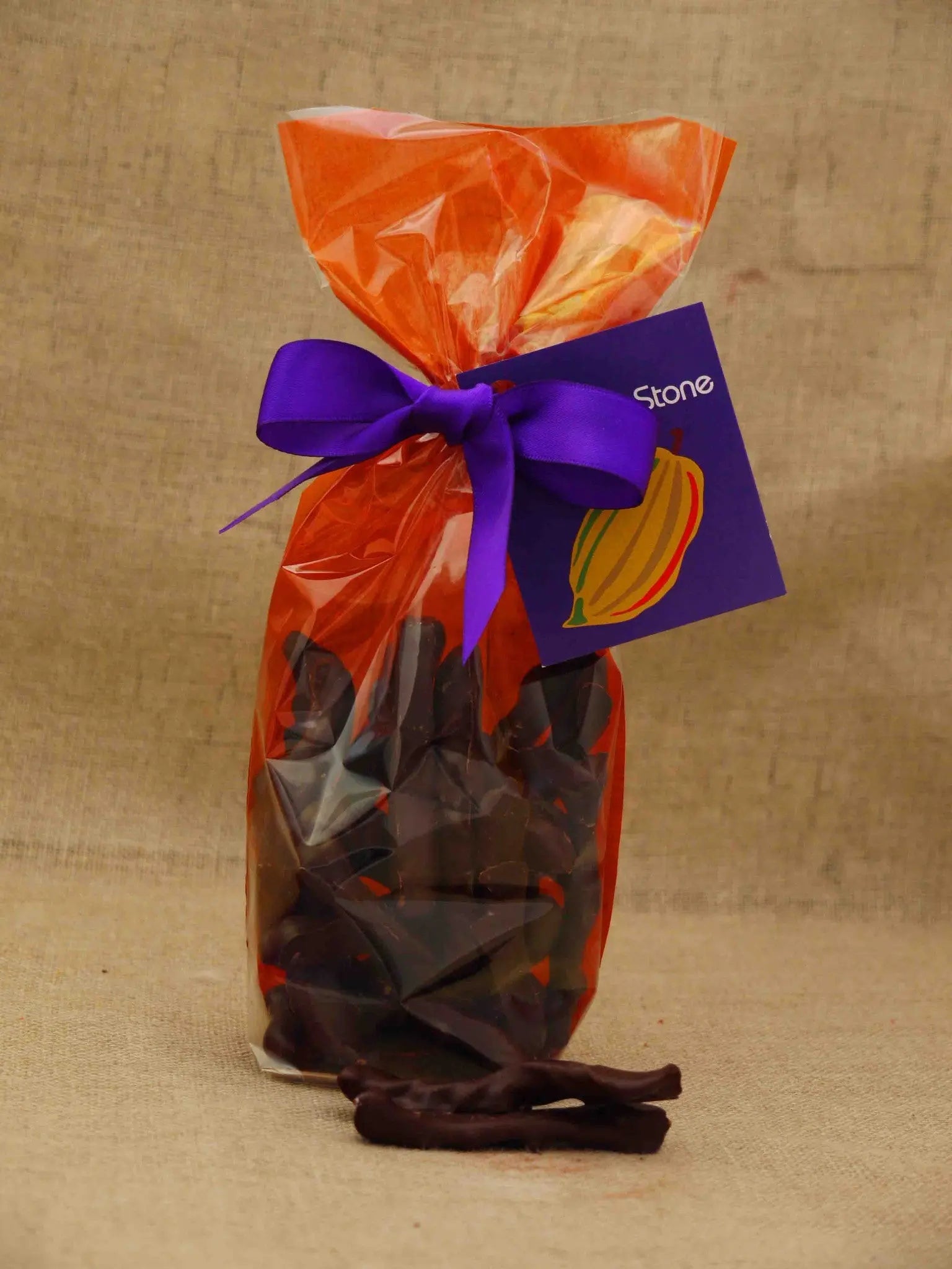 Dark chocolate orangette with candied orange peel, showcasing chocolate-covered citrus treat by Gorvett & Stone.