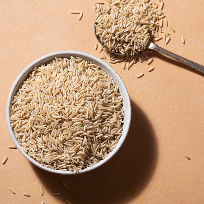 Organic Brown Basmati Rice from Whole Food Earth, showcasing fluffy, long-grain rice in a clear container.