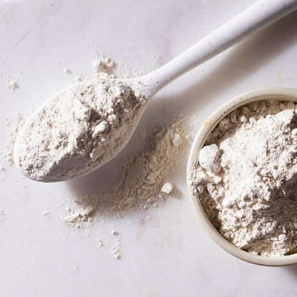 Organic Buckwheat Flour from Whole Food Earth, displayed in a clear bag with a scoop, highlighting its natural, whole grain texture.