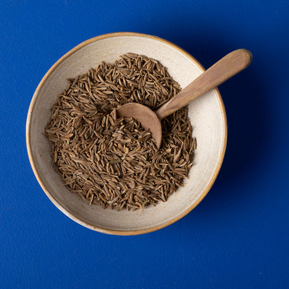 Organic caraway seeds from Whole Food Earth, wild-harvested herbs and spices in a 100g package, shown in a clear image.