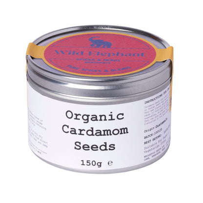 Organic cardamom seeds from Whole Food Earth, shown in a 150g package, featuring small green pods of aromatic herbs and spices.