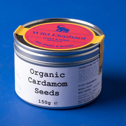 Organic cardamom seeds from Wild Elephant, 150g, showing green, aromatic spice seeds in a clear container.