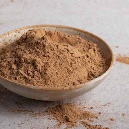 Organic carob powder from Whole Food Earth, showcasing the fine, dark powder used as a natural chocolate substitute.
