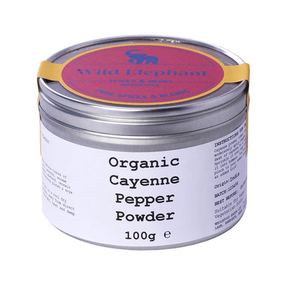 Organic cayenne pepper powder from Wild Elephant, vibrant red spice in a clear jar, labeled Herbs & Spices by Whole Food Earth.